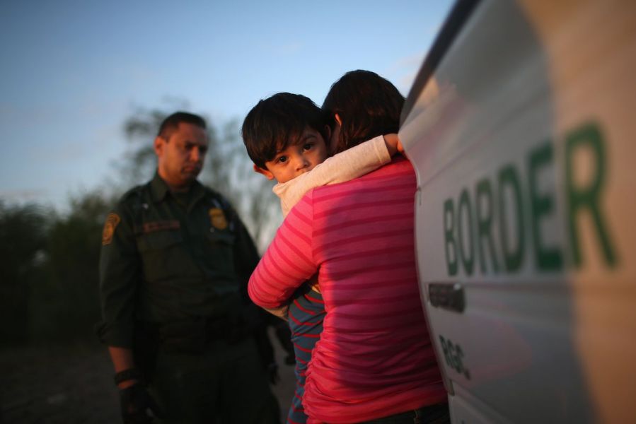 A child and mother embracing at the border.