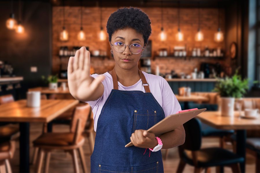 restaurant worker with hand outstretched in stop symbol