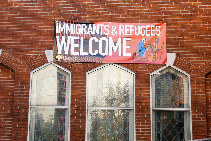 immigrants and refugees welcome sign on church