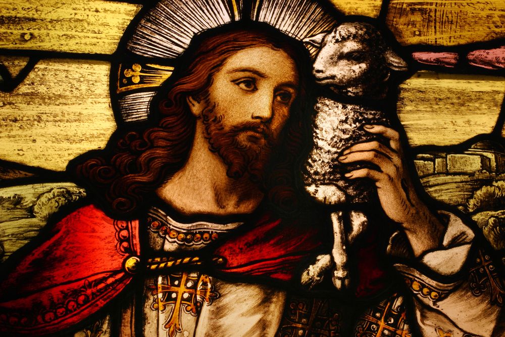 Stained glass image of Jesus with a lamb