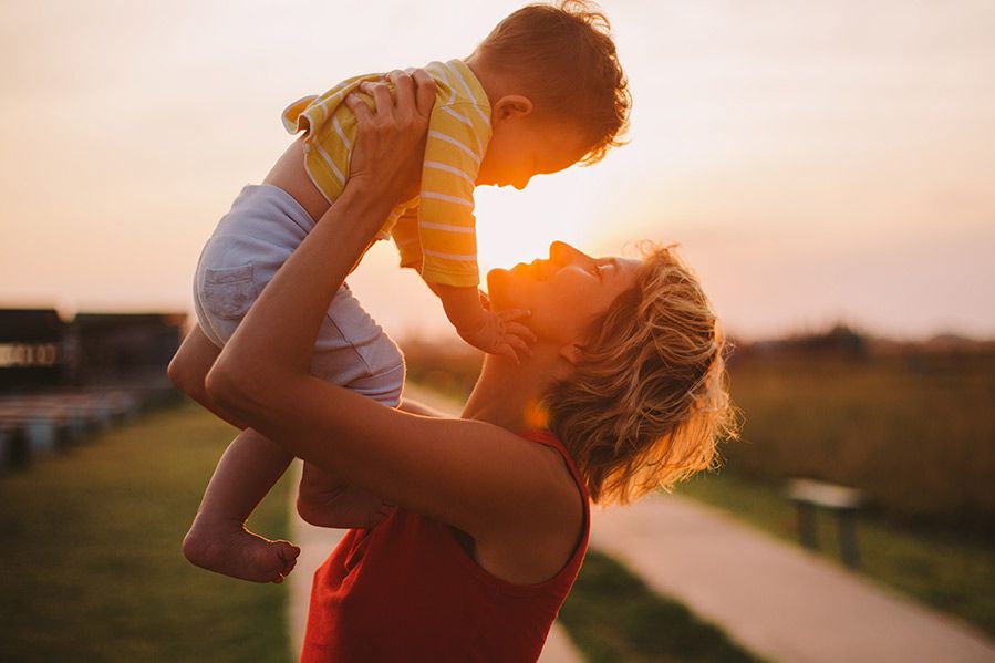 mother holding up son on mother's day