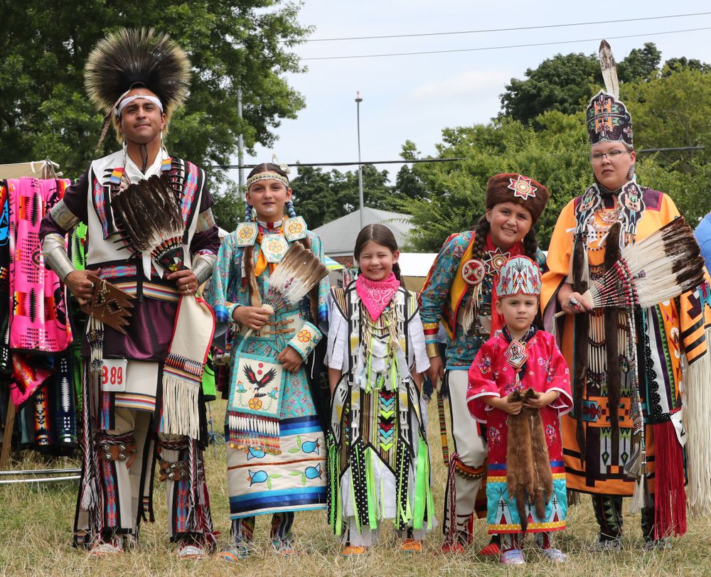 A native american family dressed in traditional clothing