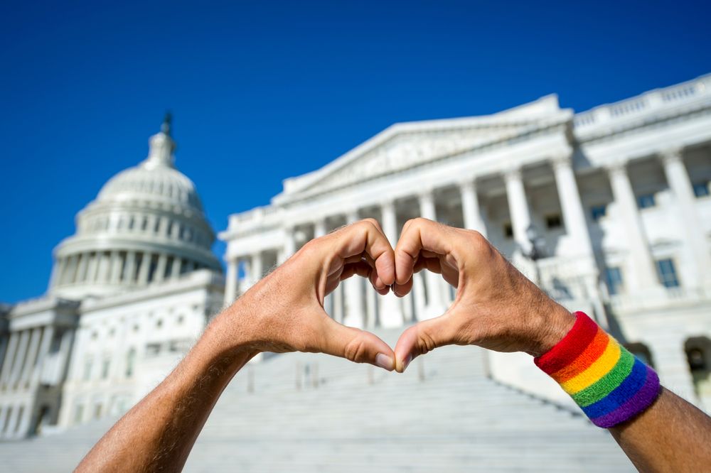 person making a heart with their hands at the capitol