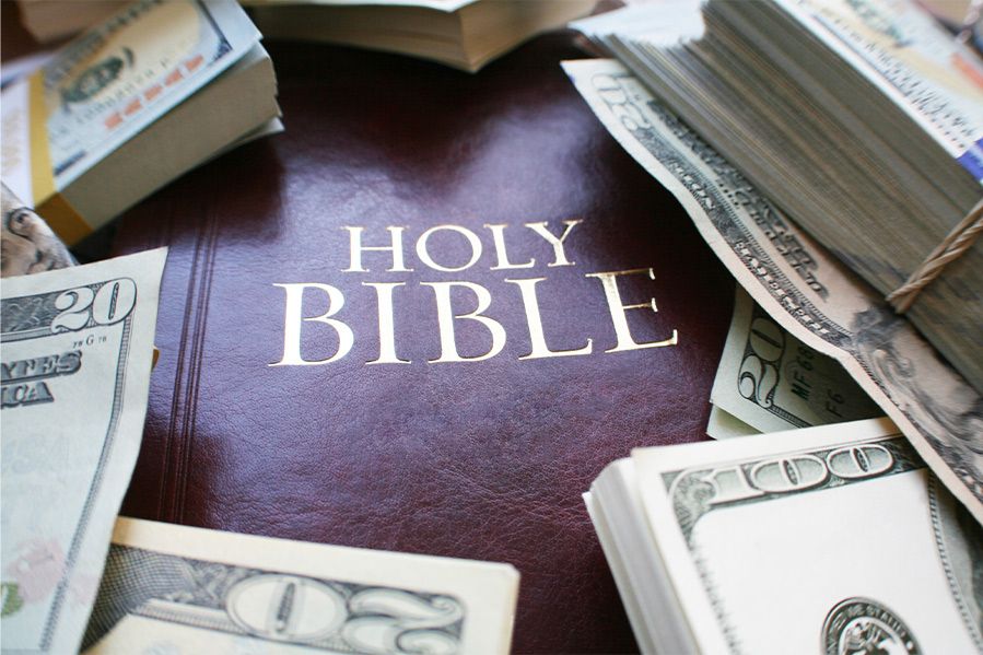 holy bible under pile of cash