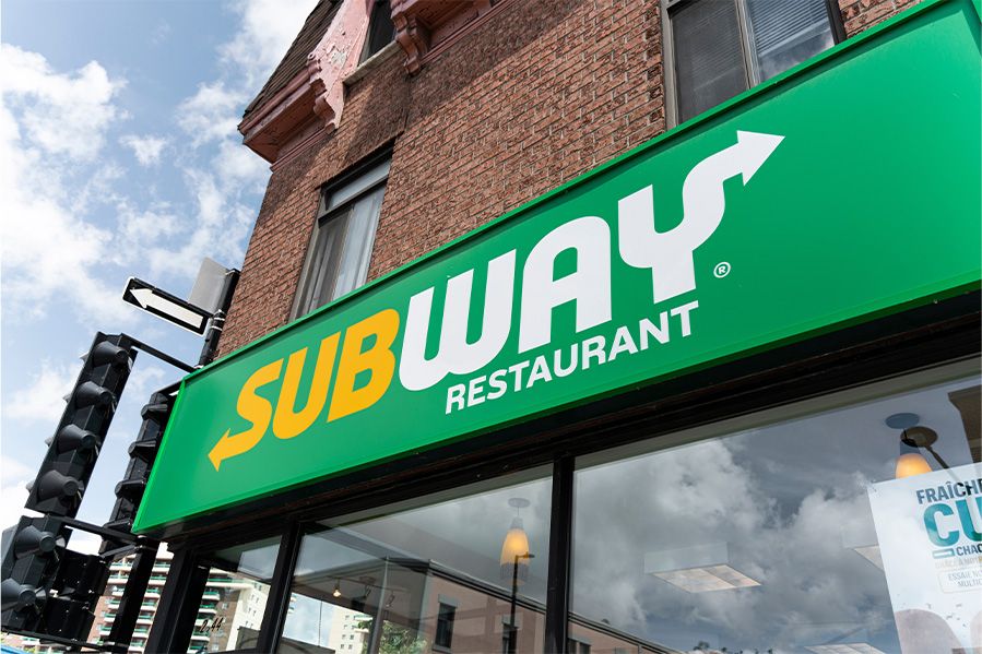 subway restaurant sign on front of building