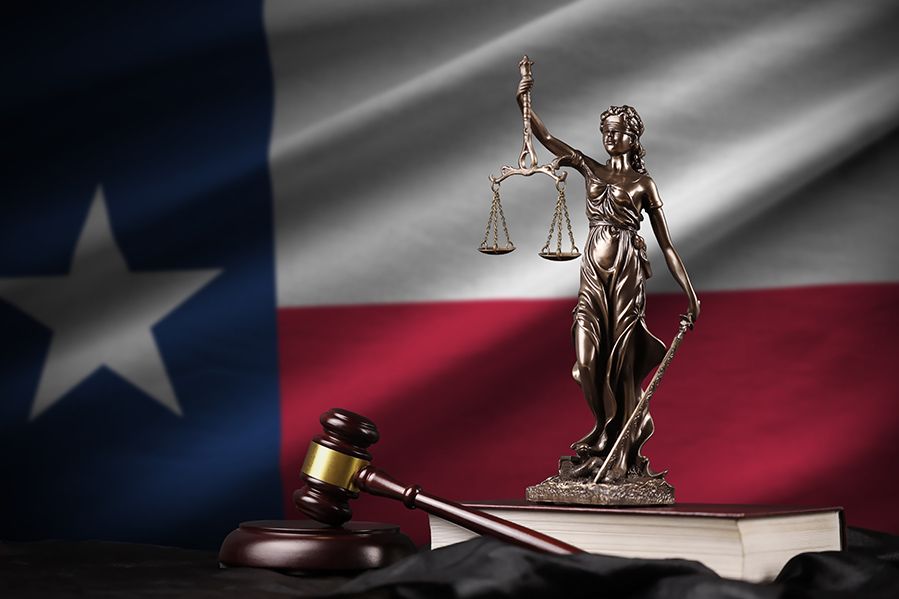 scales of justice and gavel in front of texas state flag