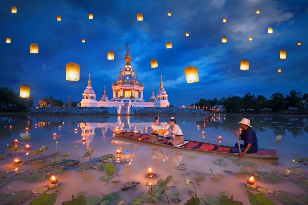 Women light lanterns during the Thai lantern festival