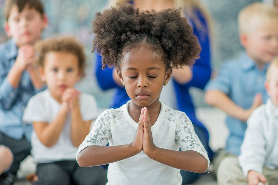 little girl praying in school