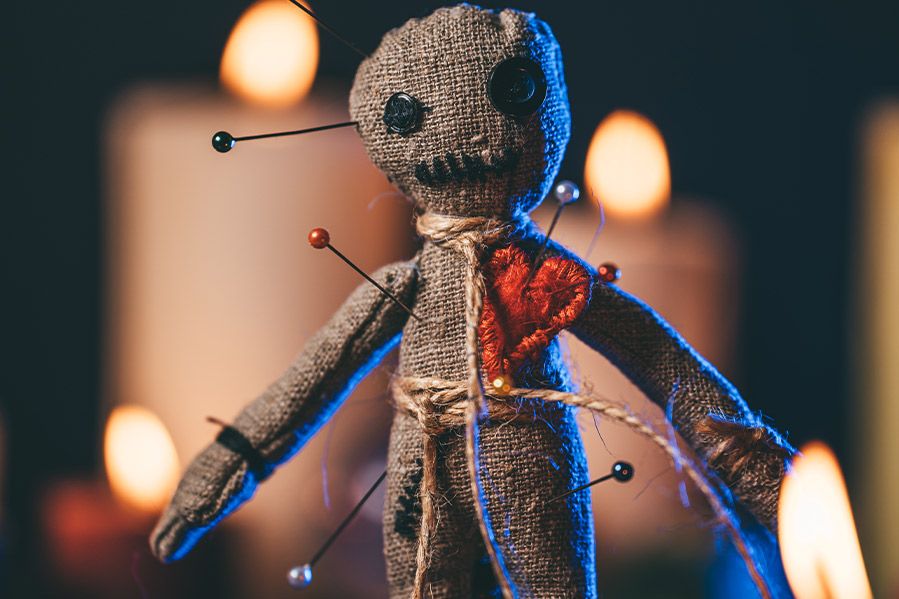 voodoo doll pierced with pins