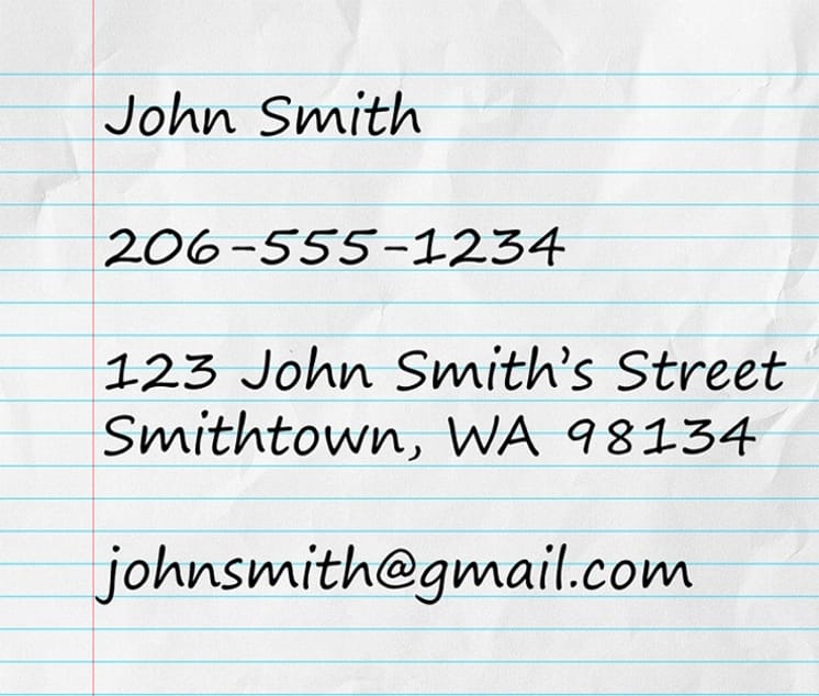 A full address written on a piece of paper, with contact information such as name, email, and phone number.