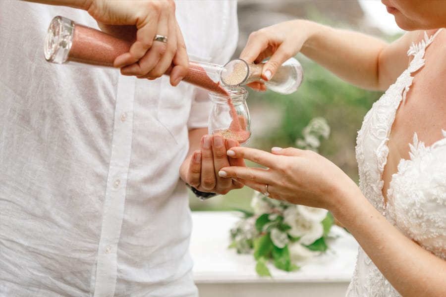 Wedding couple pouring sand in show of unity