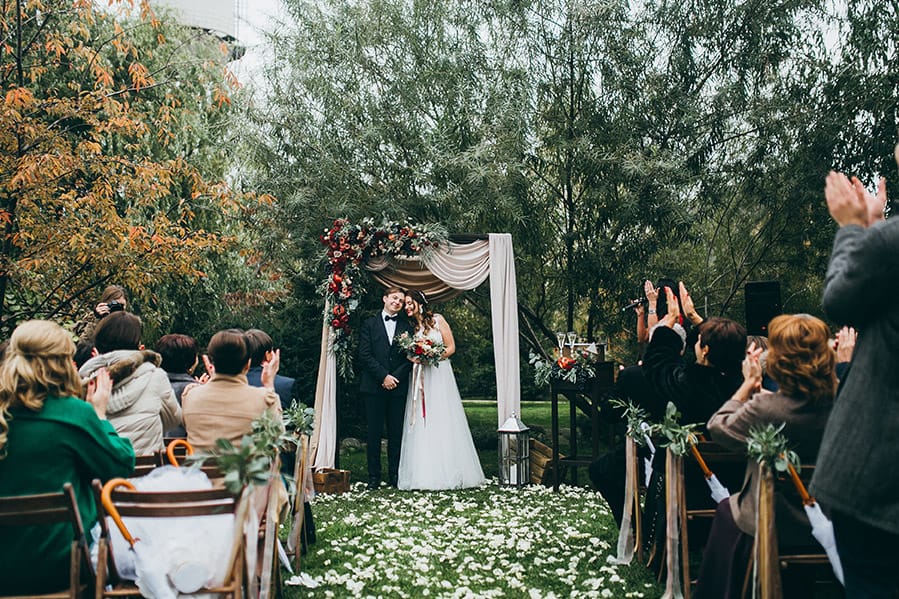 Bride and Groom embracing in a spiritual outdoor wedding venue.